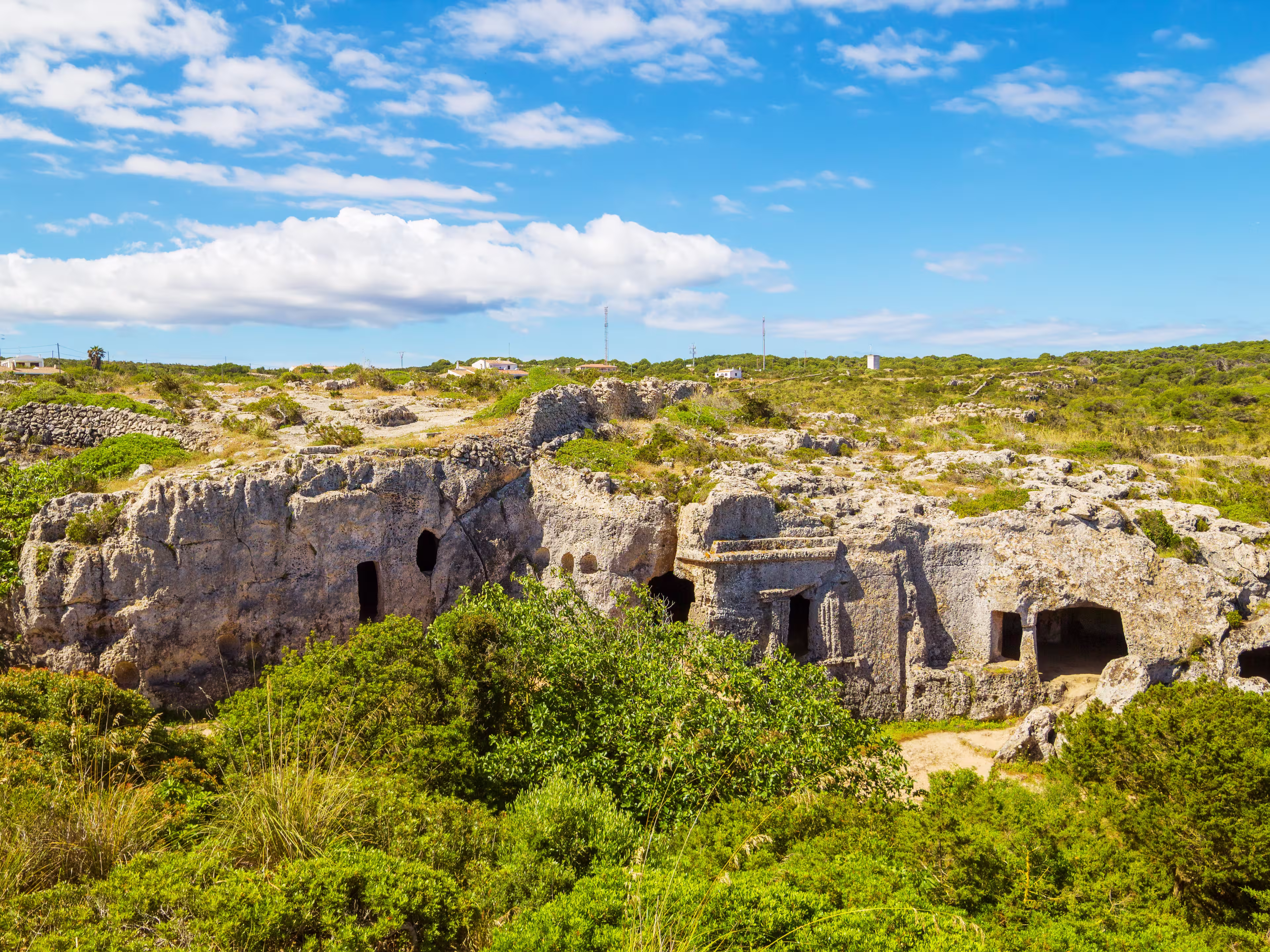 Cala Morell Necropolis Caves in sunny day at Menorca, Spain.