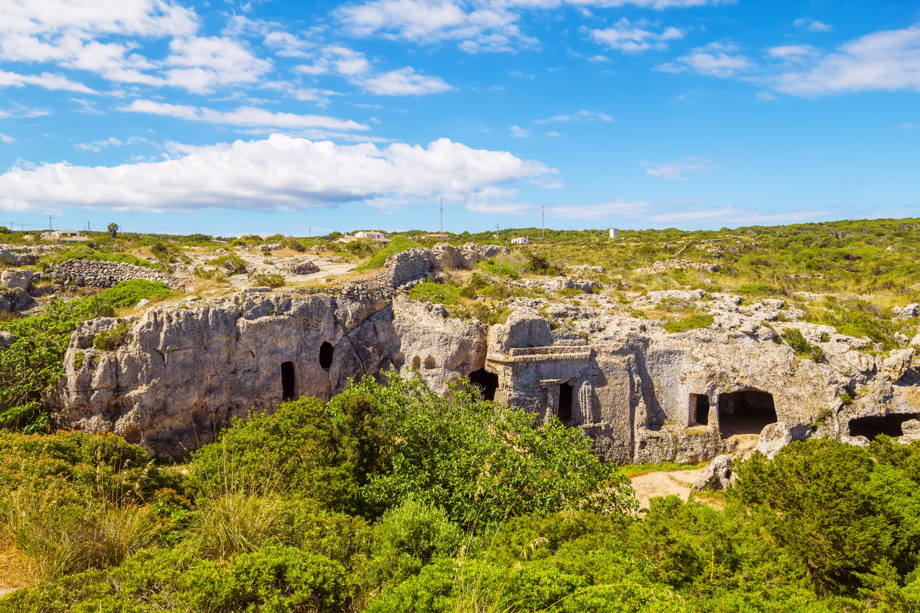 Cala Morell Necropolis Caves in sunny day at Menorca, Spain.