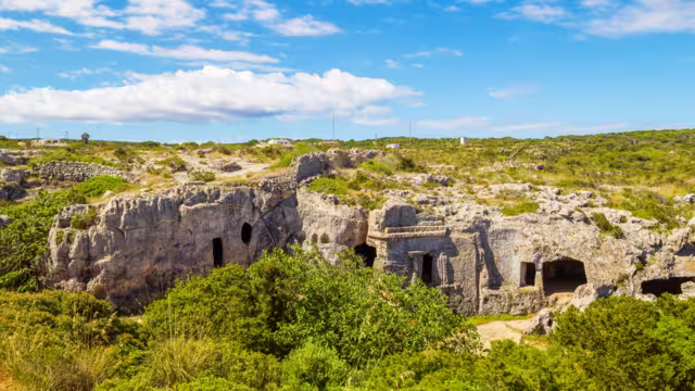 Cala Morell Necropolis Caves in sunny day at Menorca, Spain.
