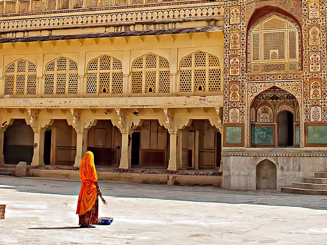 HHPHC - Persona walking through decorative gate of Amber Fort in Jaipur, India