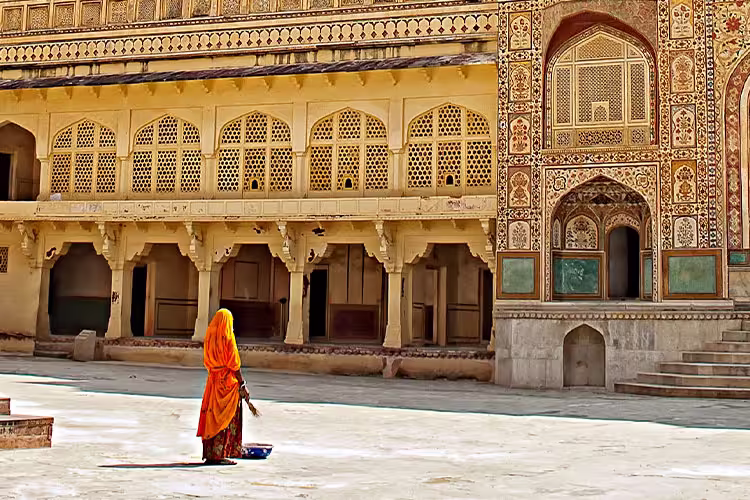 HHPHC - Persona walking through decorative gate of Amber Fort in Jaipur, India