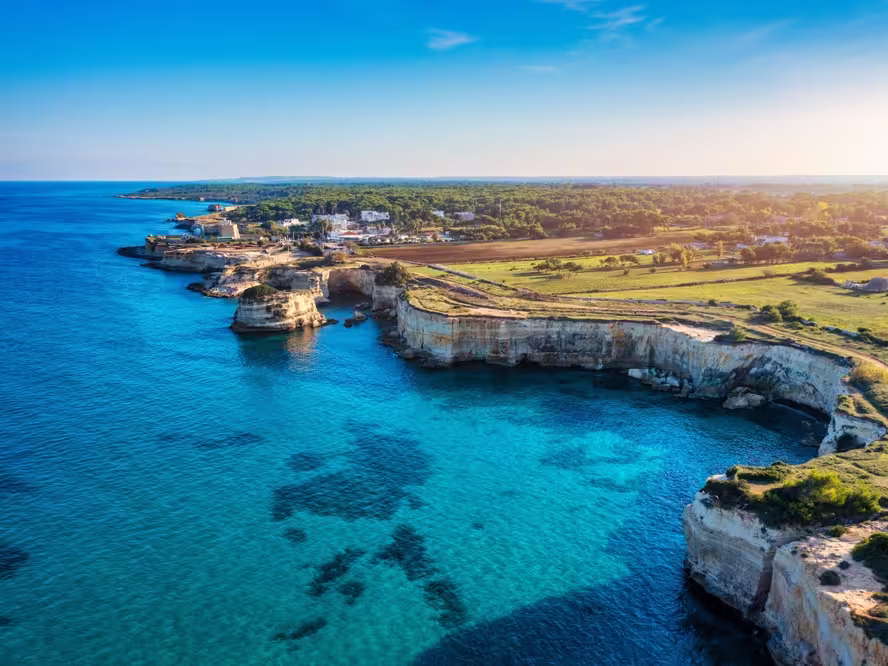 Stunning seascape with cliffs rocky arch and stacks (Faraglioni) at Torre Sant Andrea, Salento coast, Puglia region, Italy. Beautiful cliffs and sea stacks of Sant'Andrea, Salento, Apulia, Italy