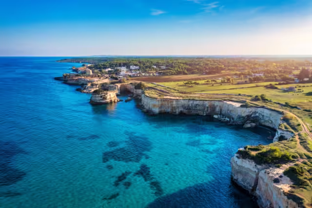 Stunning seascape with cliffs rocky arch and stacks (Faraglioni) at Torre Sant Andrea, Salento coast, Puglia region, Italy. Beautiful cliffs and sea stacks of Sant'Andrea, Salento, Apulia, Italy