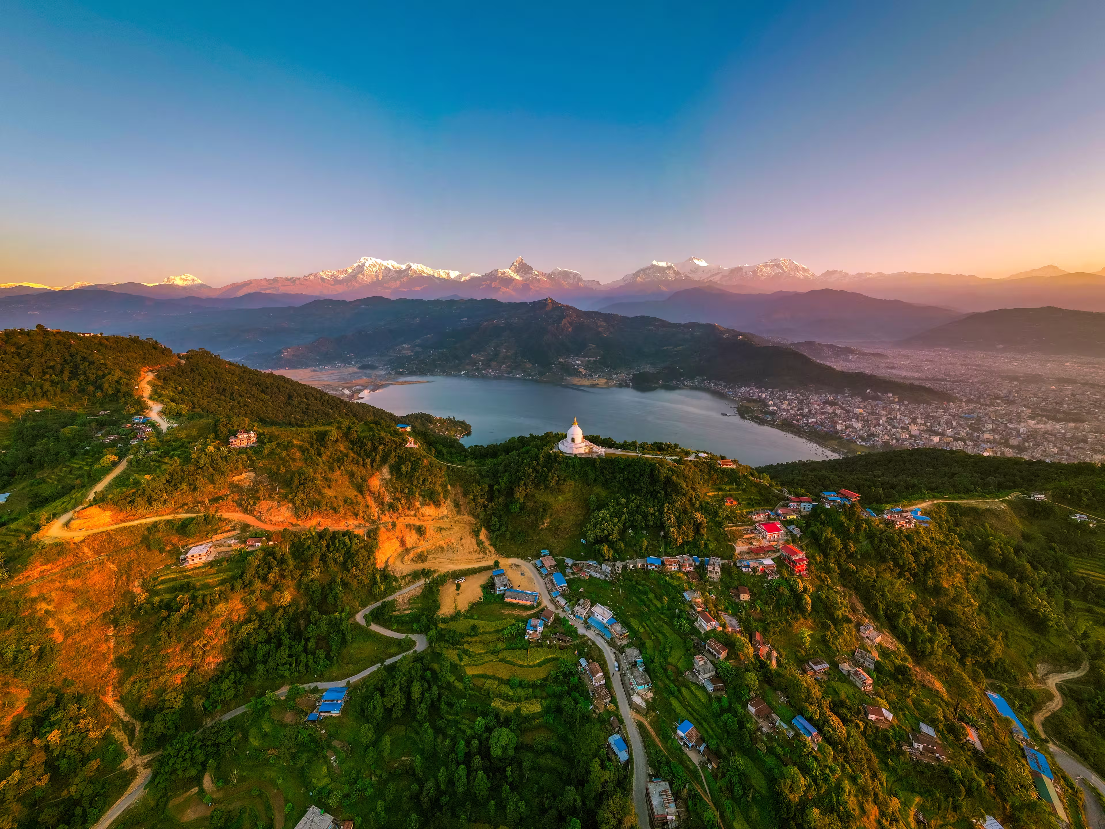 Scenic view of Pokhara city with the Annapurna mountain range — stunning Himalayas, serene lakeside landscape, and iconic Nepal travel destination.