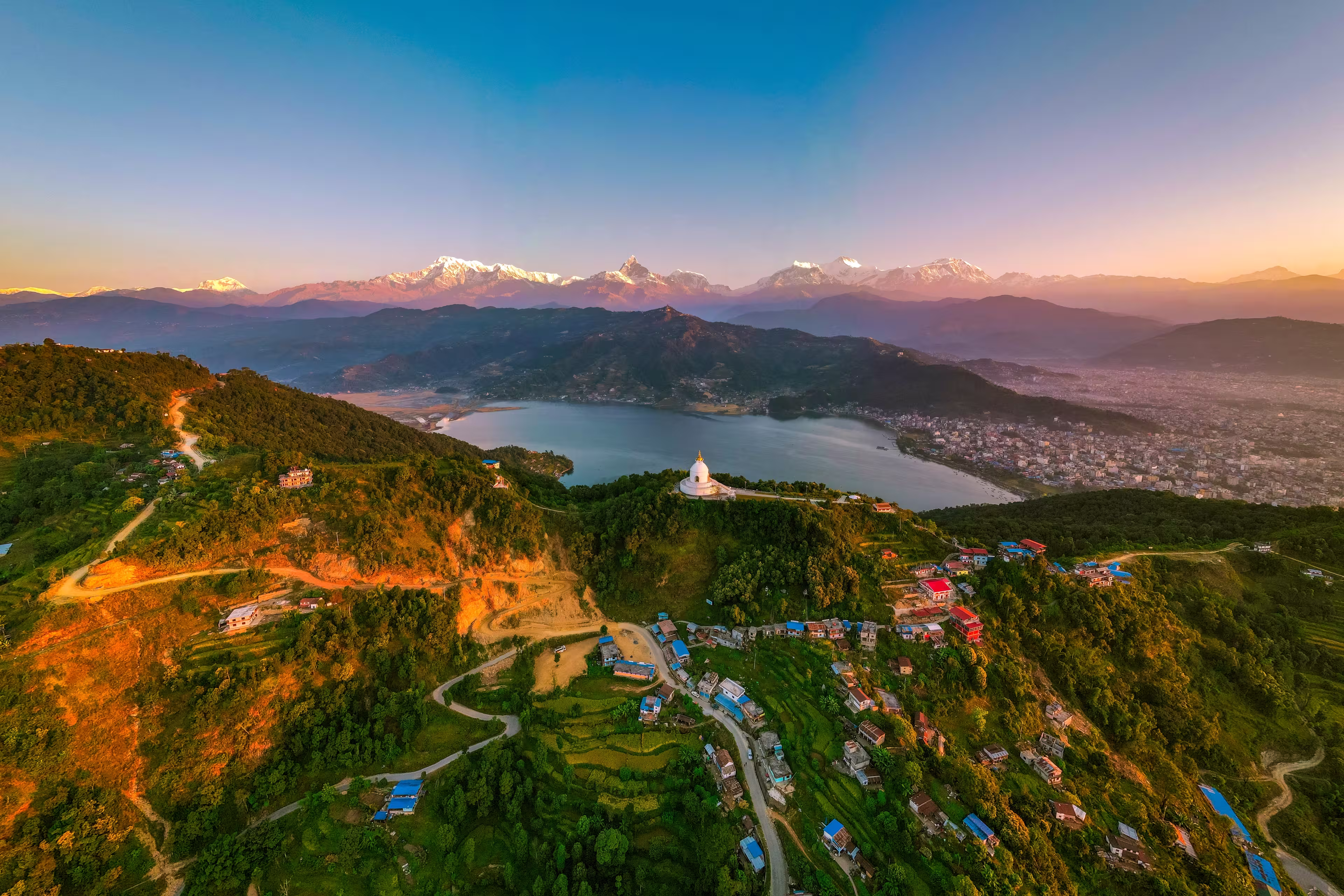 Scenic view of Pokhara city with the Annapurna mountain range — stunning Himalayas, serene lakeside landscape, and iconic Nepal travel destination.
