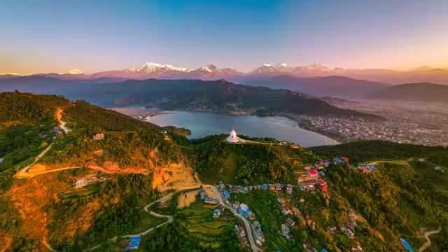 Scenic view of Pokhara city with the Annapurna mountain range — stunning Himalayas, serene lakeside landscape, and iconic Nepal travel destination.