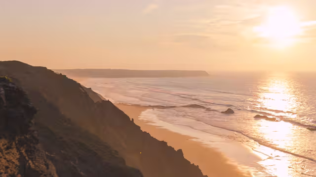 Traveller hiking along coastline of Rota Vicentina at sunset, Portgual