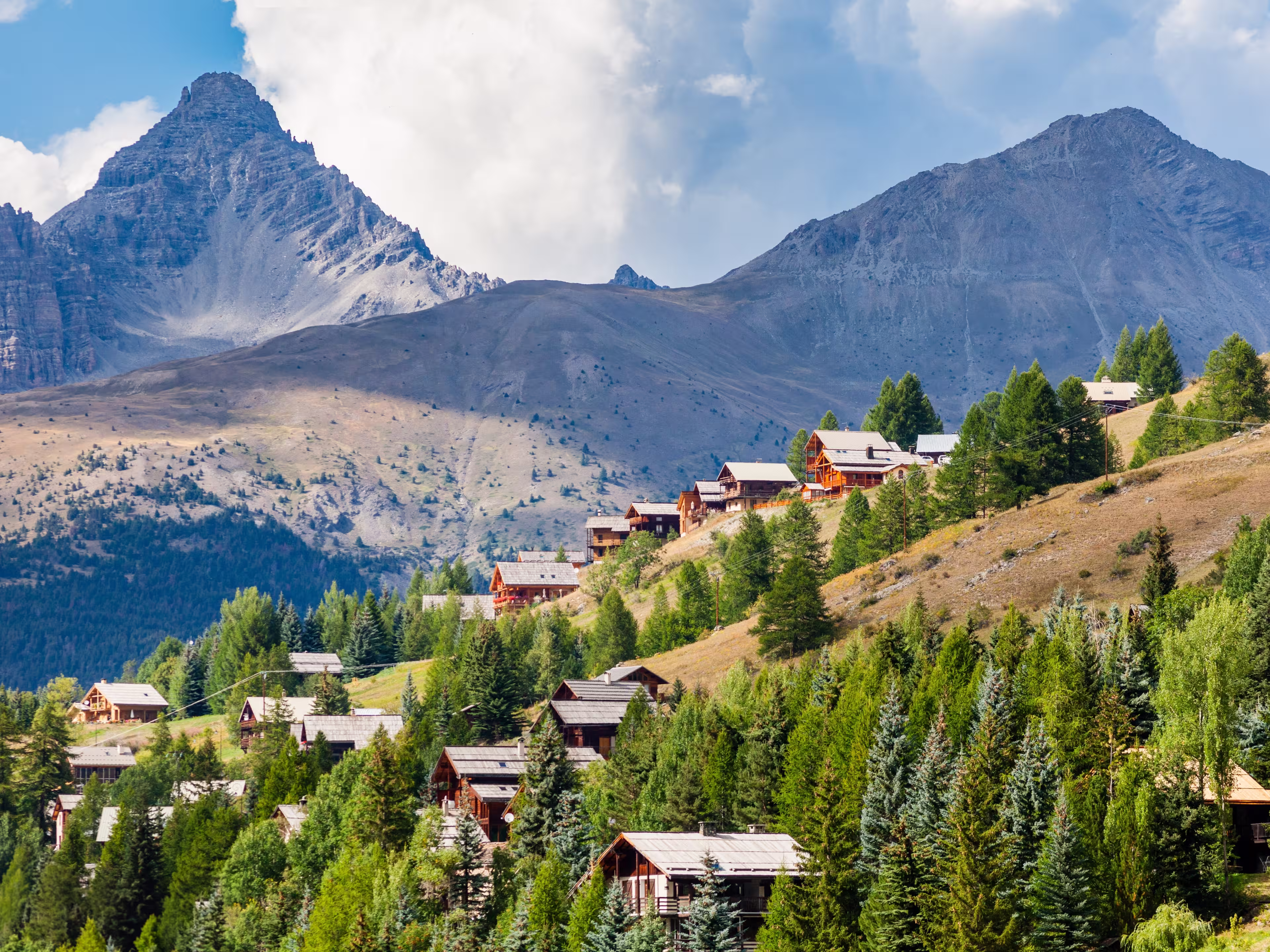 Molines-en-Queyras, Provence, France: charming mountain village, with chalet wooden houses and Queyras peaks in background, in "Alpes de Haute-Provence", near Saint-Veran and Nice