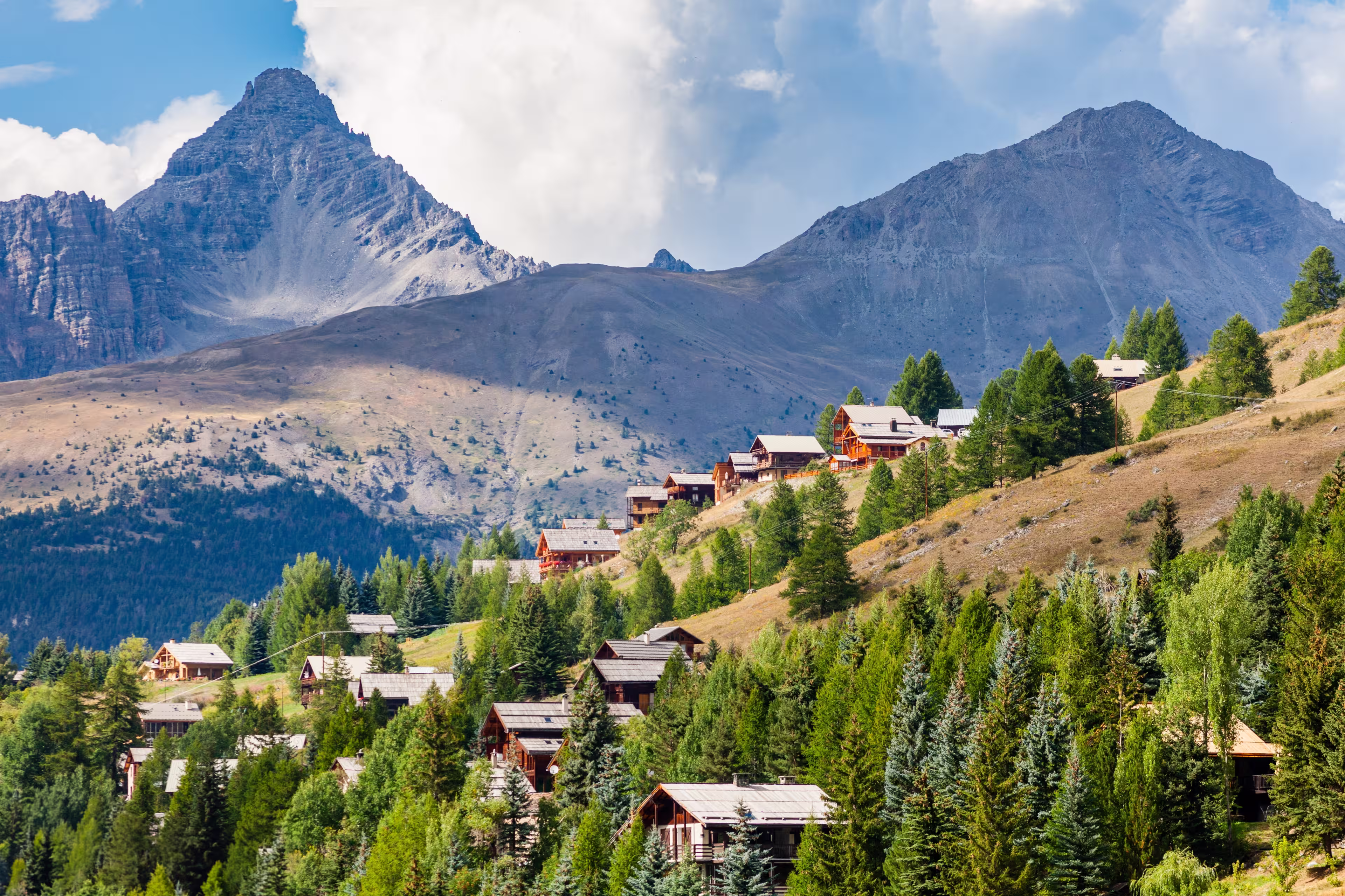 Molines-en-Queyras, Provence, France: charming mountain village, with chalet wooden houses and Queyras peaks in background, in "Alpes de Haute-Provence", near Saint-Veran and Nice