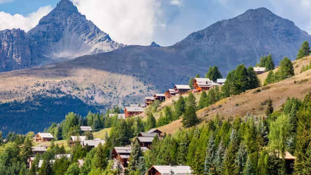 Molines-en-Queyras, Provence, France: charming mountain village, with chalet wooden houses and Queyras peaks in background, in "Alpes de Haute-Provence", near Saint-Veran and Nice