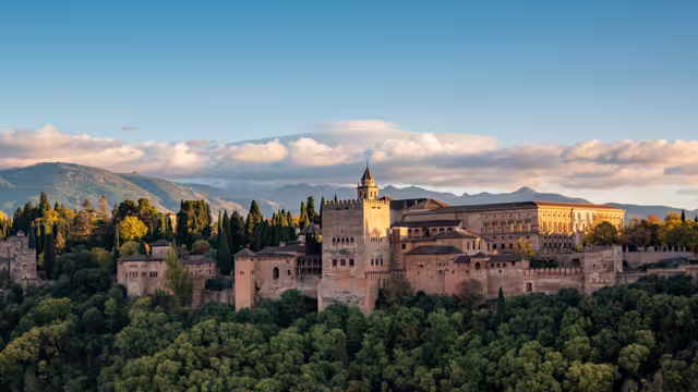 Alhambra, the arabic castle in Granada, Andalucia, Spain - Sierra Nevada mountains in background. Seen from plaza de San Nicolas Albaycin