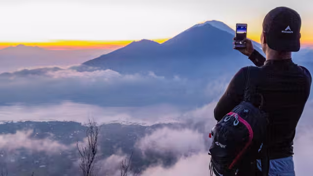Watch the sunrise from Mt Batur, on the Essential Bali & Gili Islands trip with Intrepid Travel