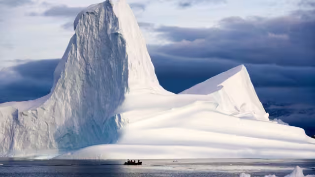 Get up close with one of the iconic Scoresbysund icebergs
