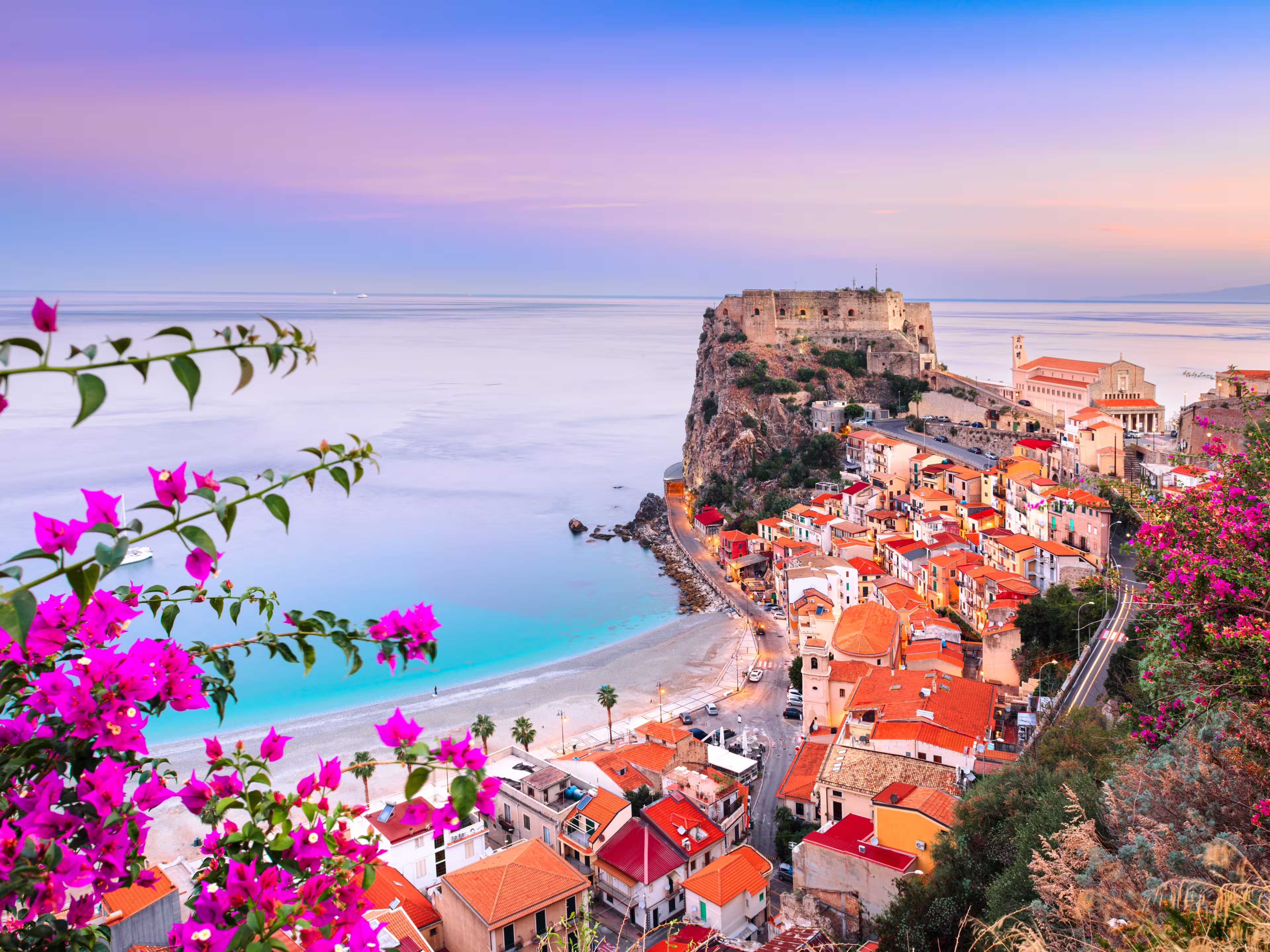 Scilla, Italy historic townscape on the coast of the Mediterranean Sea at dawn.