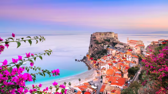 Scilla, Italy historic townscape on the coast of the Mediterranean Sea at dawn.