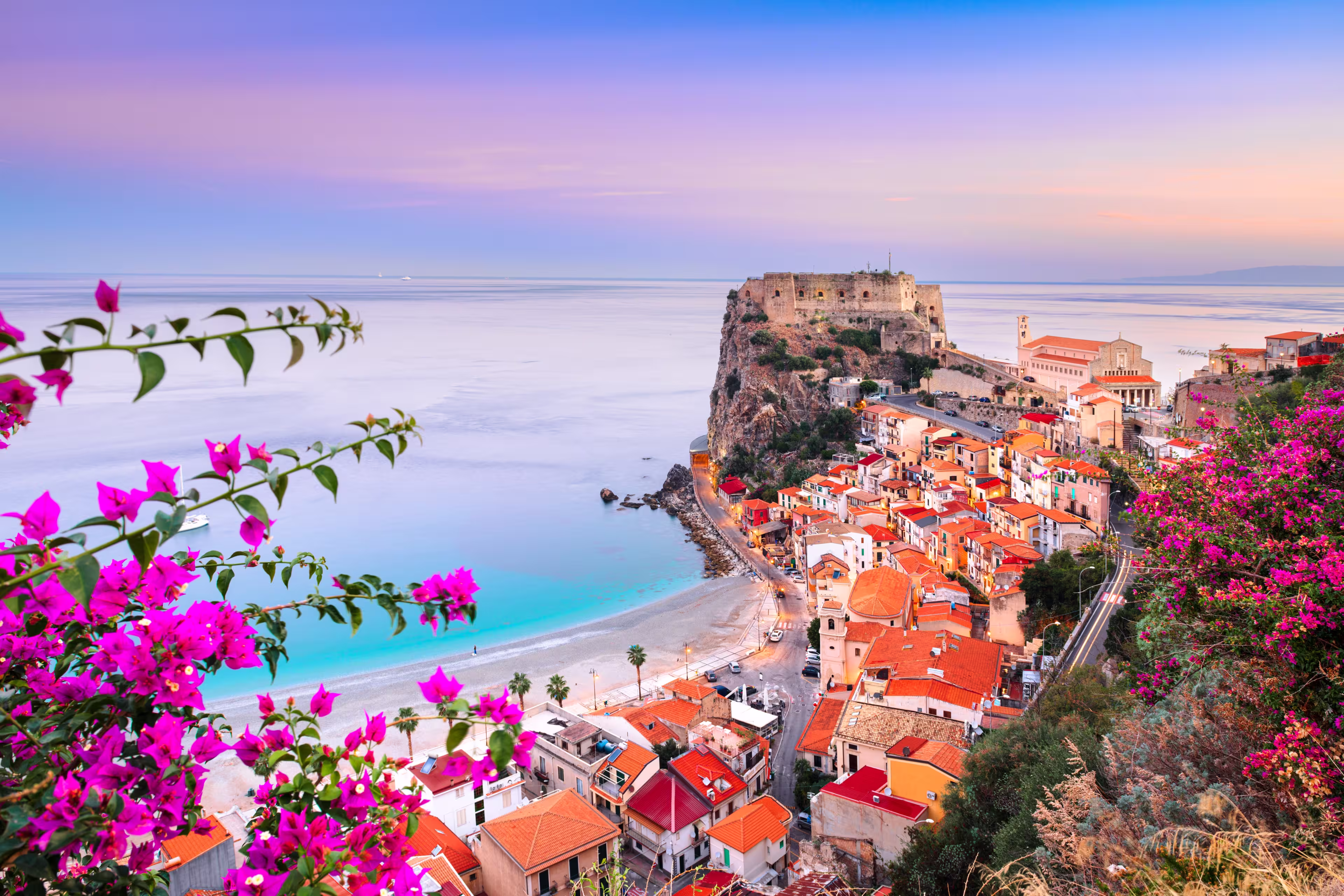 Scilla, Italy historic townscape on the coast of the Mediterranean Sea at dawn.