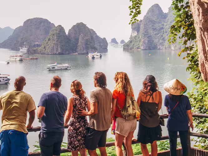 TVPHC - Group in cave overlooking boats in Ha Long Bay, Vietnam