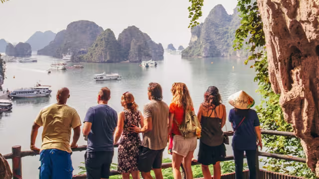 TVPHC - Group in cave overlooking boats in Ha Long Bay, Vietnam