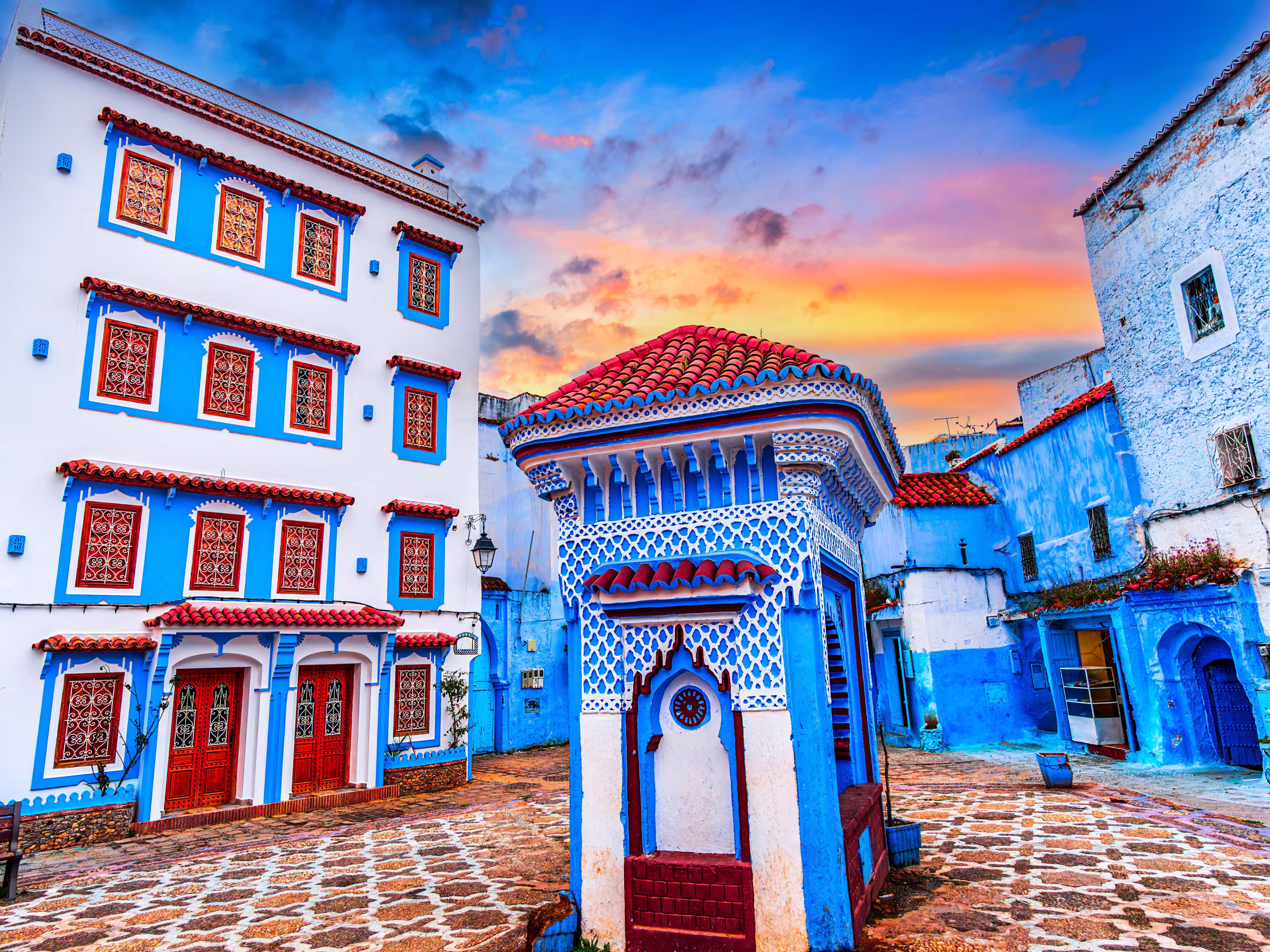 Chefchaouen, Morocco: Blue narow stairs with colourful walls and flowerpots into old walled city, or medina, North Africa