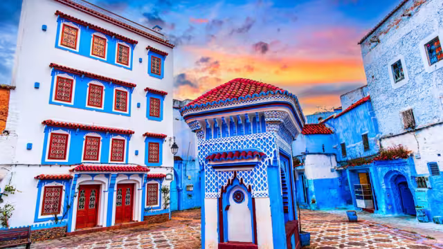 Chefchaouen, Morocco: Blue narow stairs with colourful walls and flowerpots into old walled city, or medina, North Africa