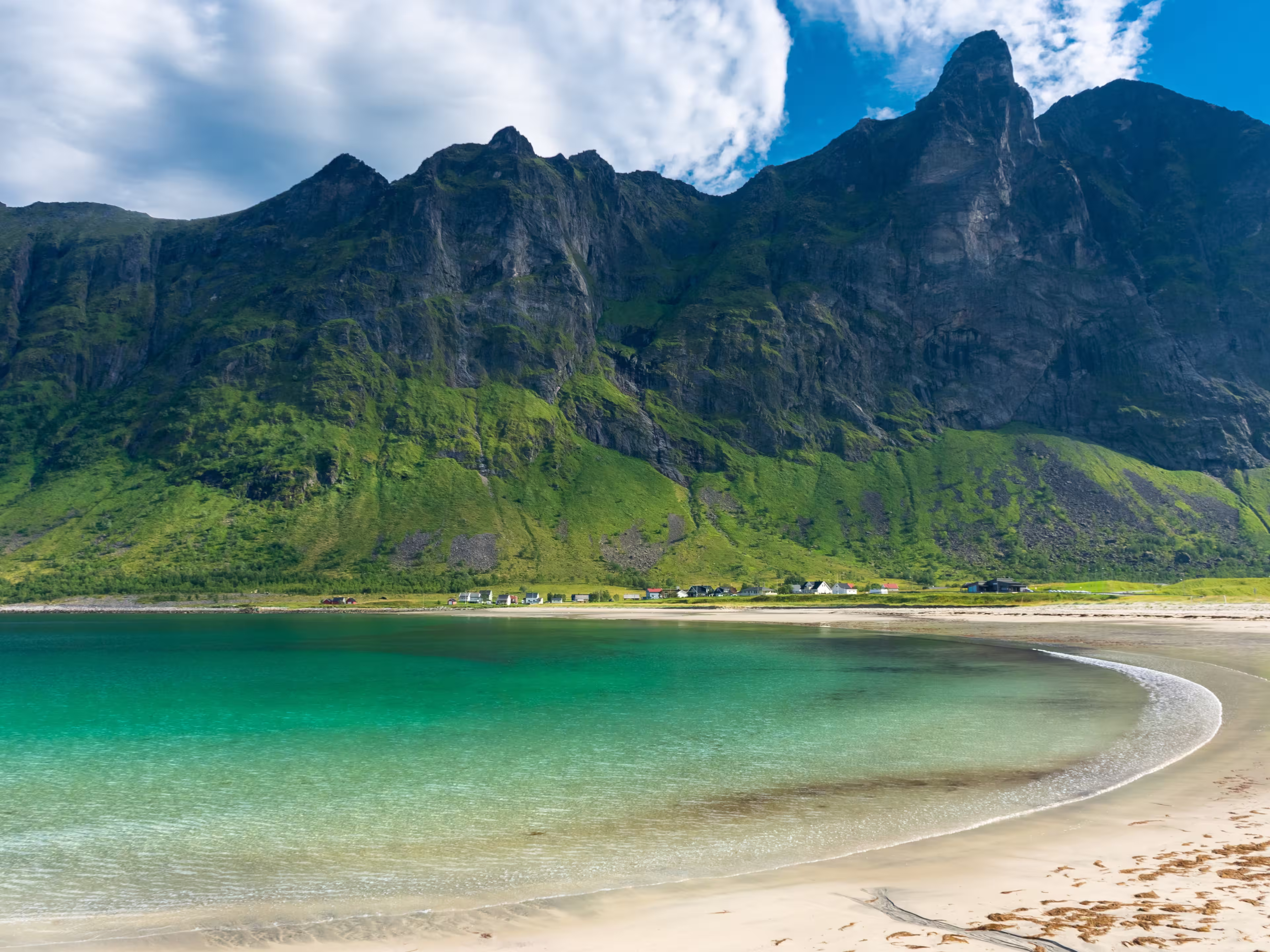 The crystal clear water of the Ersfjordstranda beach in Senja Island, Norway