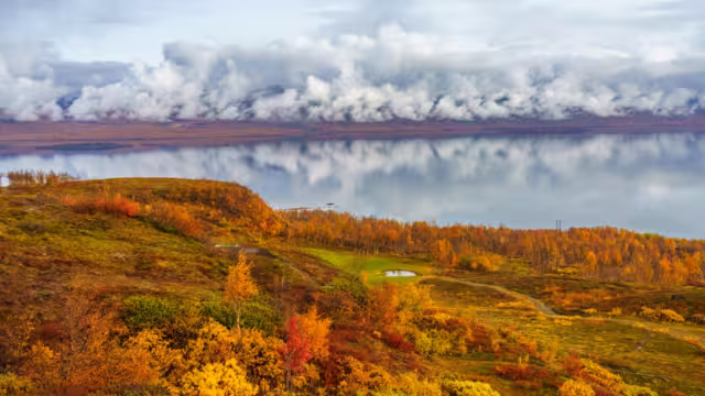 Autumn season in Abisko with Lapporten in background, and Björkliden golf course in foreground, taken from Björkliden, Swedish Lapland, Sweden