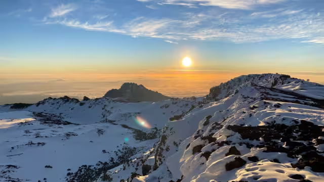 Amazing panorama from Uhuru Peak. Dawn in the mountains. Snow-covered crater of Mount Kilimanjaro. Climbing Kilimanjaro, Tanzania, Africa.