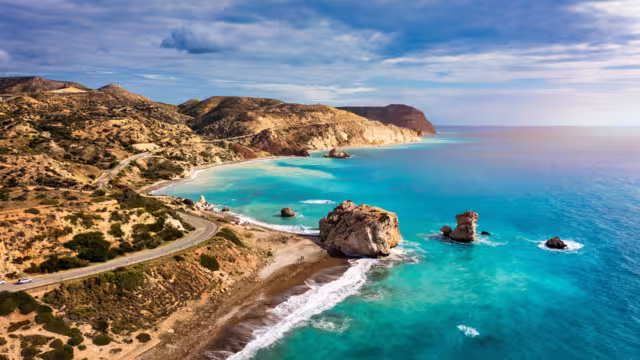 Petra tou Romiou (Aphrodite's Rock) the birthplace of Aphrodite, Paphos, Cyprus. Aerial view of Petra tou Romiou, aka Aphrodite's rock a famous tourist travel destination landmark in Paphos, Cyprus.
