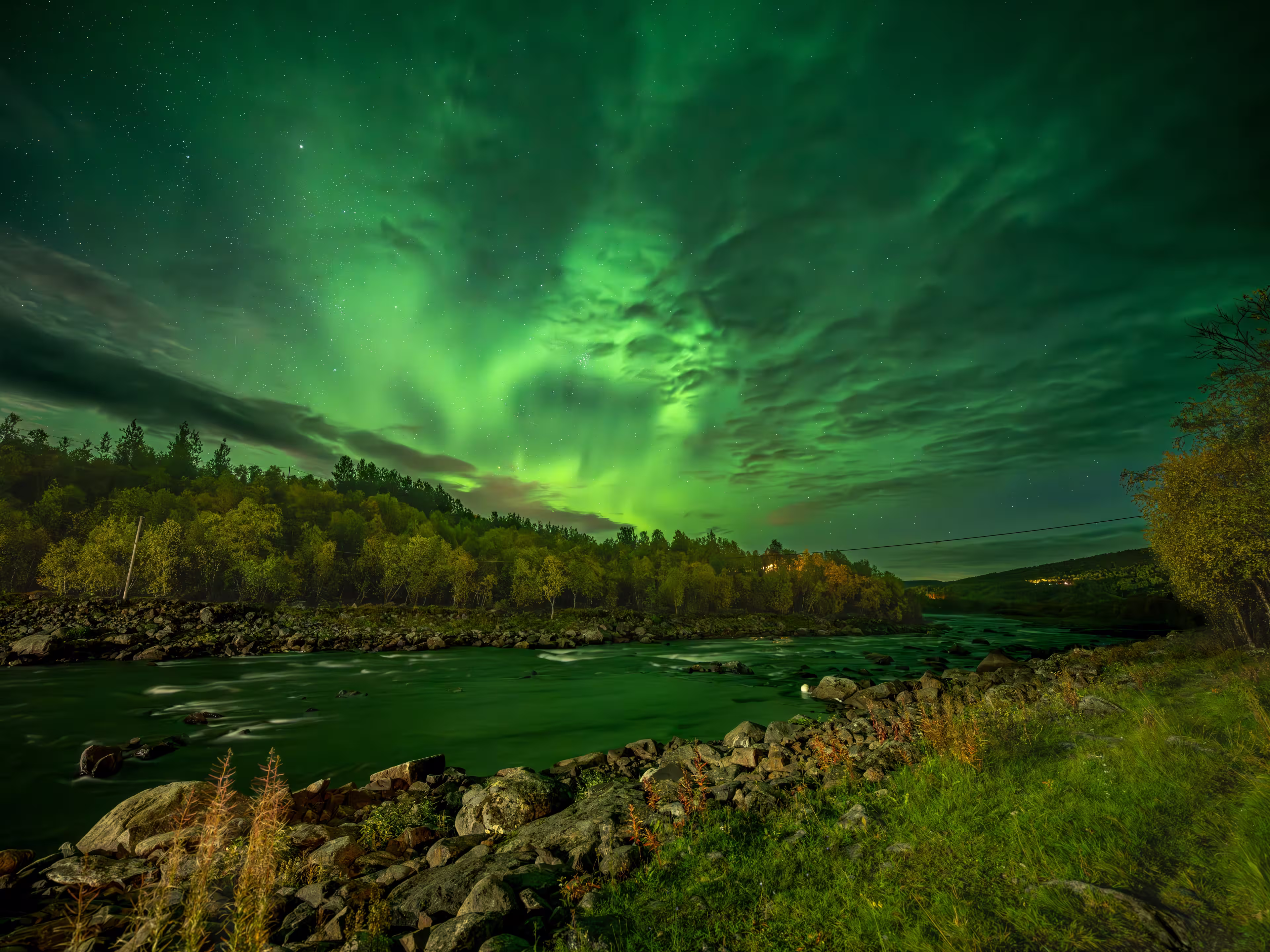 Northern lights over Neiden in the Sør-Varanger, Northeast Norway, with vibrant aurora colors illuminating the Arctic night sky.