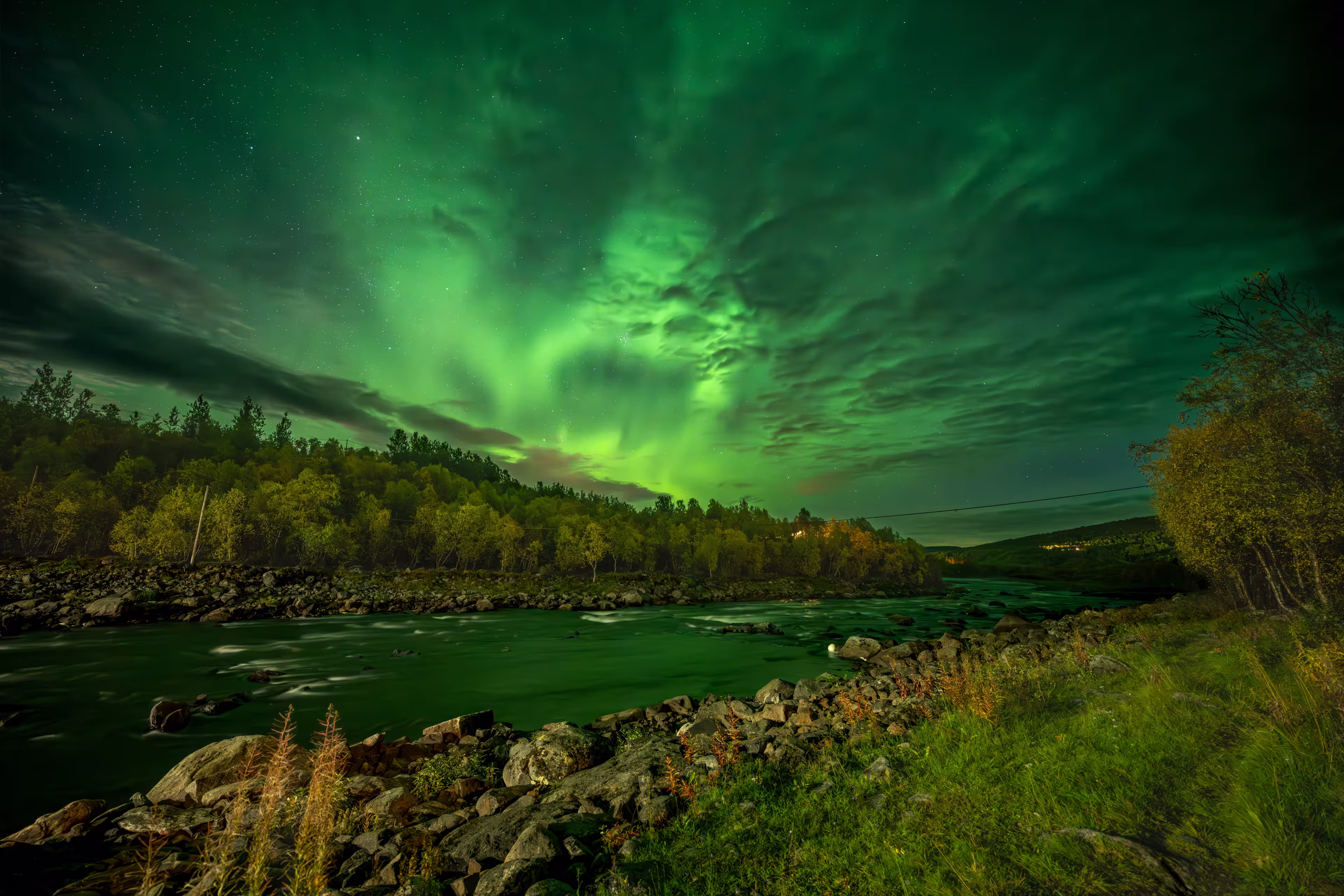 Northern lights over Neiden in the Sør-Varanger, Northeast Norway, with vibrant aurora colors illuminating the Arctic night sky.