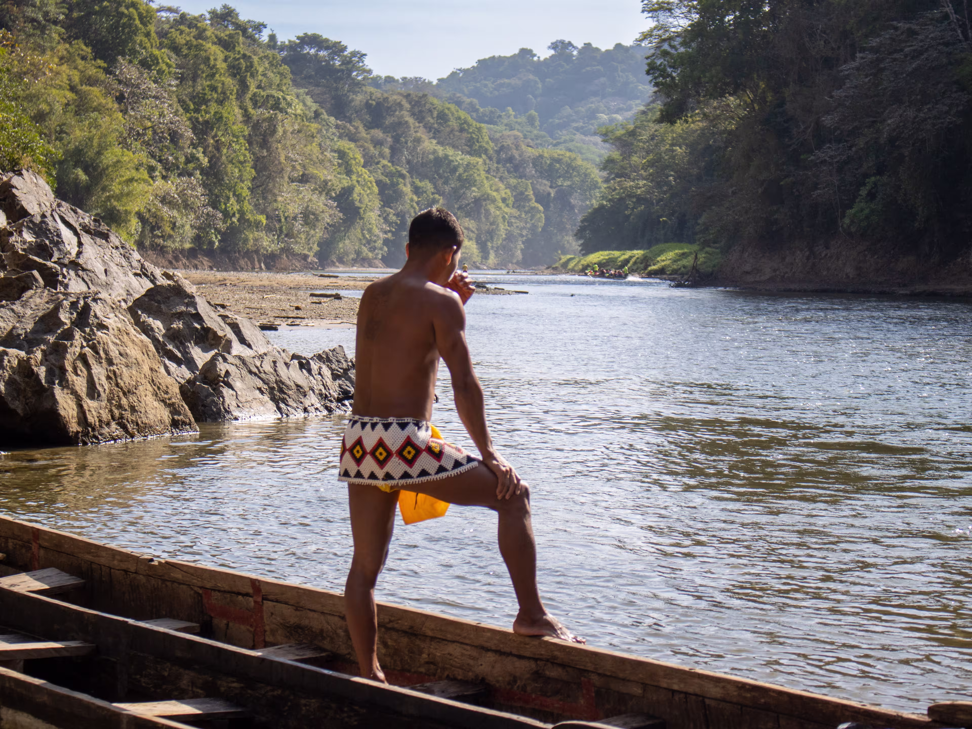 Member of the Emberá Indigenous people contemplates the Chagres River in the midst of Panama's rainforest