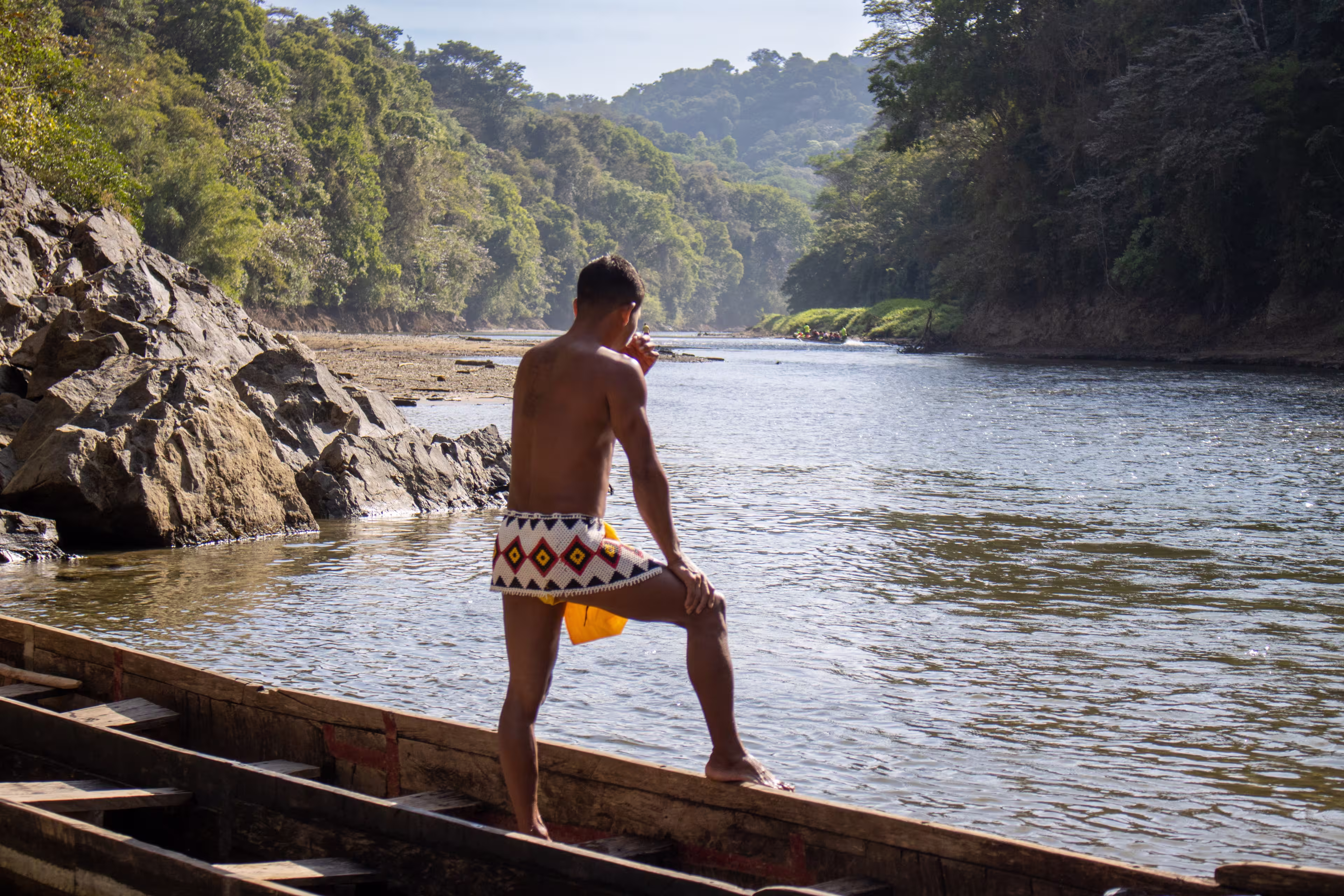 Member of the Emberá Indigenous people contemplates the Chagres River in the midst of Panama's rainforest