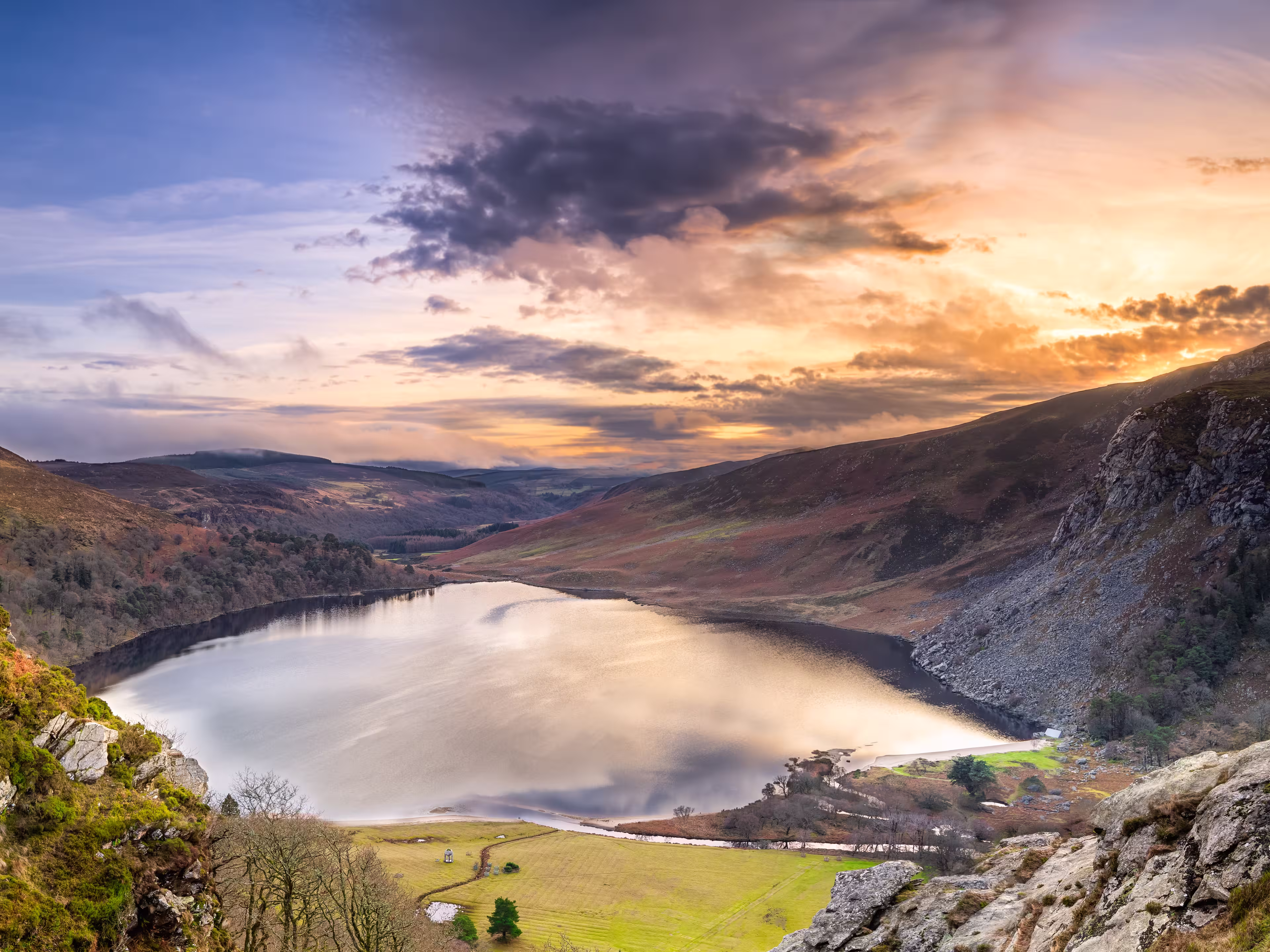 Dramatic sunset at Lake Lough Tay or The Guinness Lake in County Wicklow where Vikings village, Kattegat was located, Wicklow Mountains, Ireland
