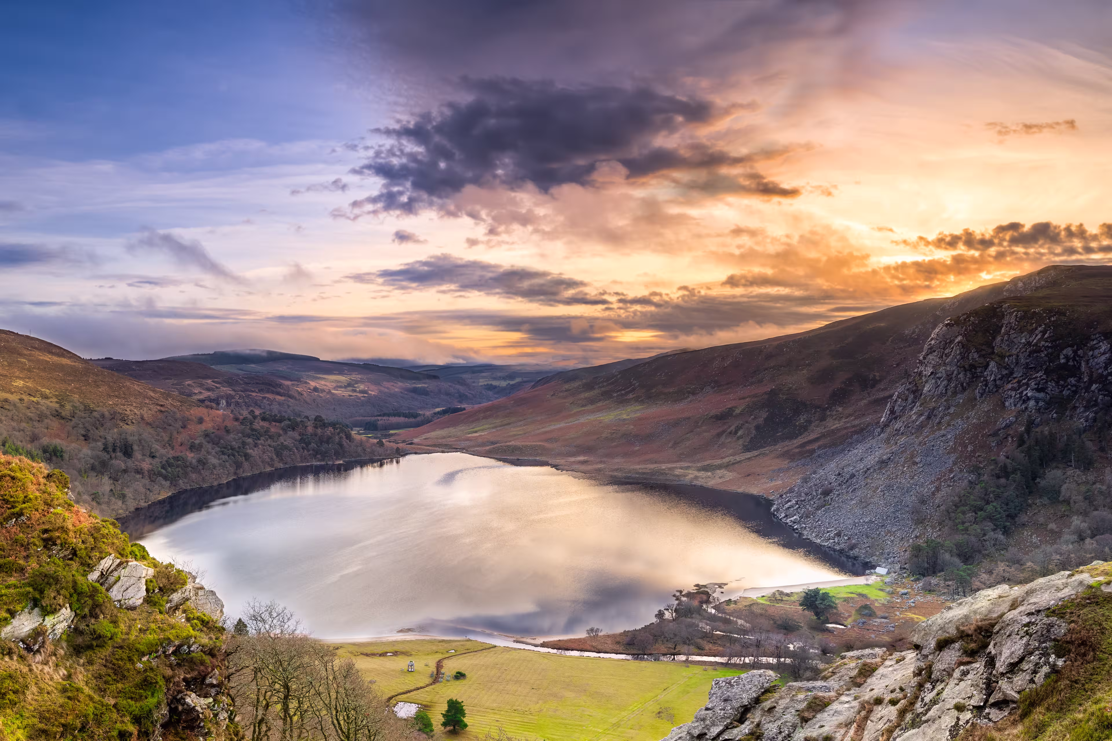 Dramatic sunset at Lake Lough Tay or The Guinness Lake in County Wicklow where Vikings village, Kattegat was located, Wicklow Mountains, Ireland