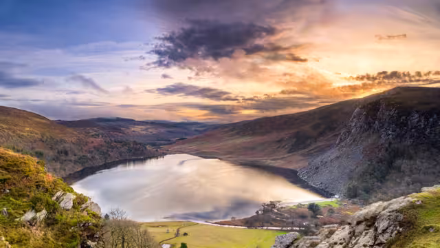 Dramatic sunset at Lake Lough Tay or The Guinness Lake in County Wicklow where Vikings village, Kattegat was located, Wicklow Mountains, Ireland