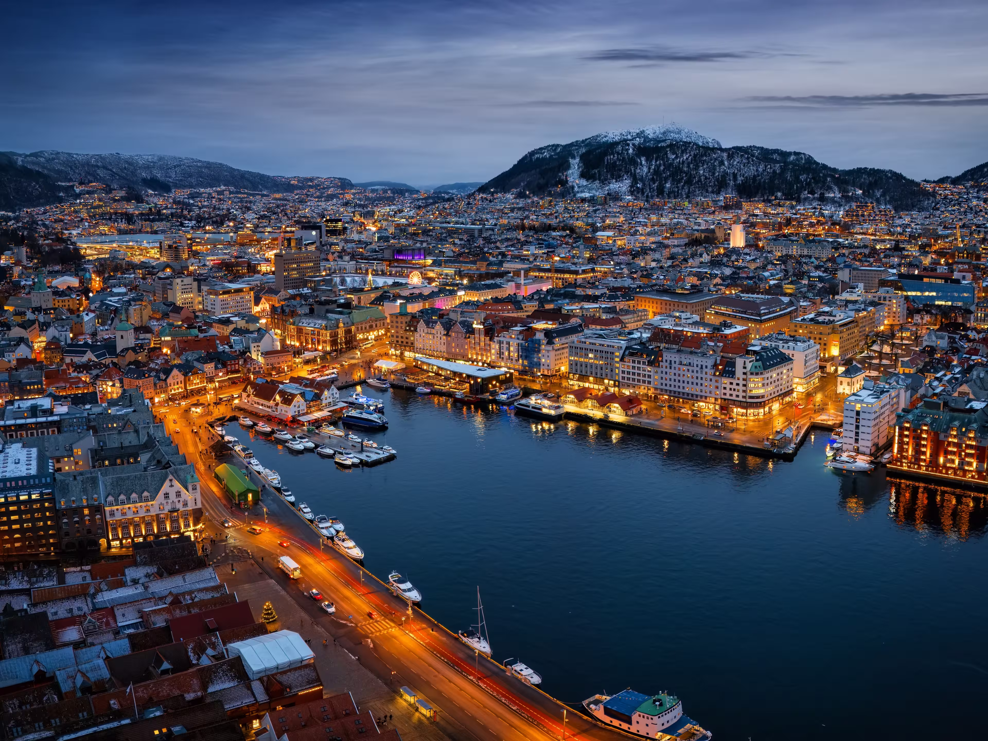 Panoramic aerial view of the illuminated cityscape of Bergen, Norway, during a cold winter night