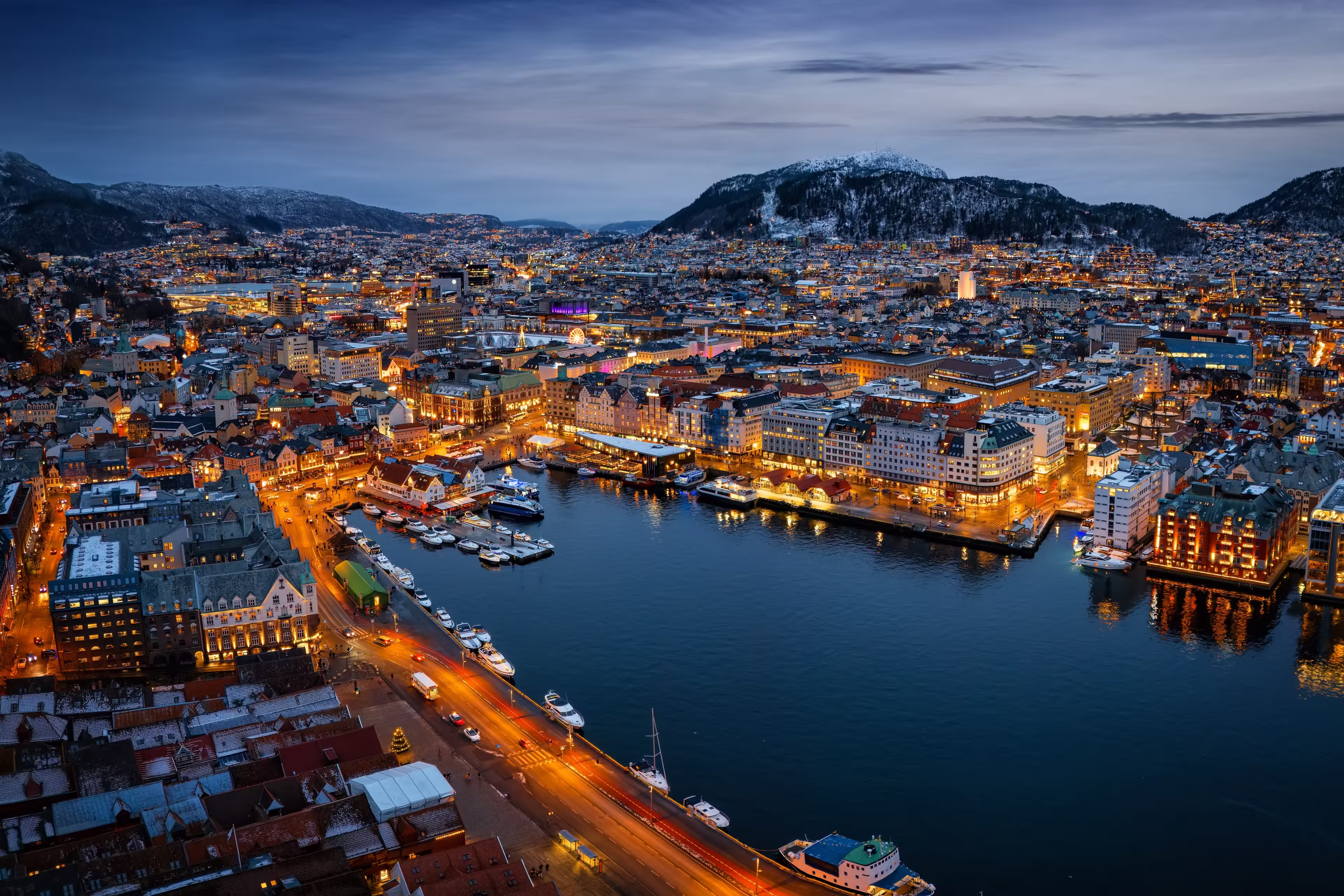Panoramic aerial view of the illuminated cityscape of Bergen, Norway, during a cold winter night