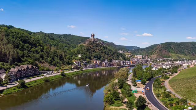 With the bike on the cycle path through the countryside along the river Moselle in Rhineland-Palatinate from Trier to Koblenz in summer