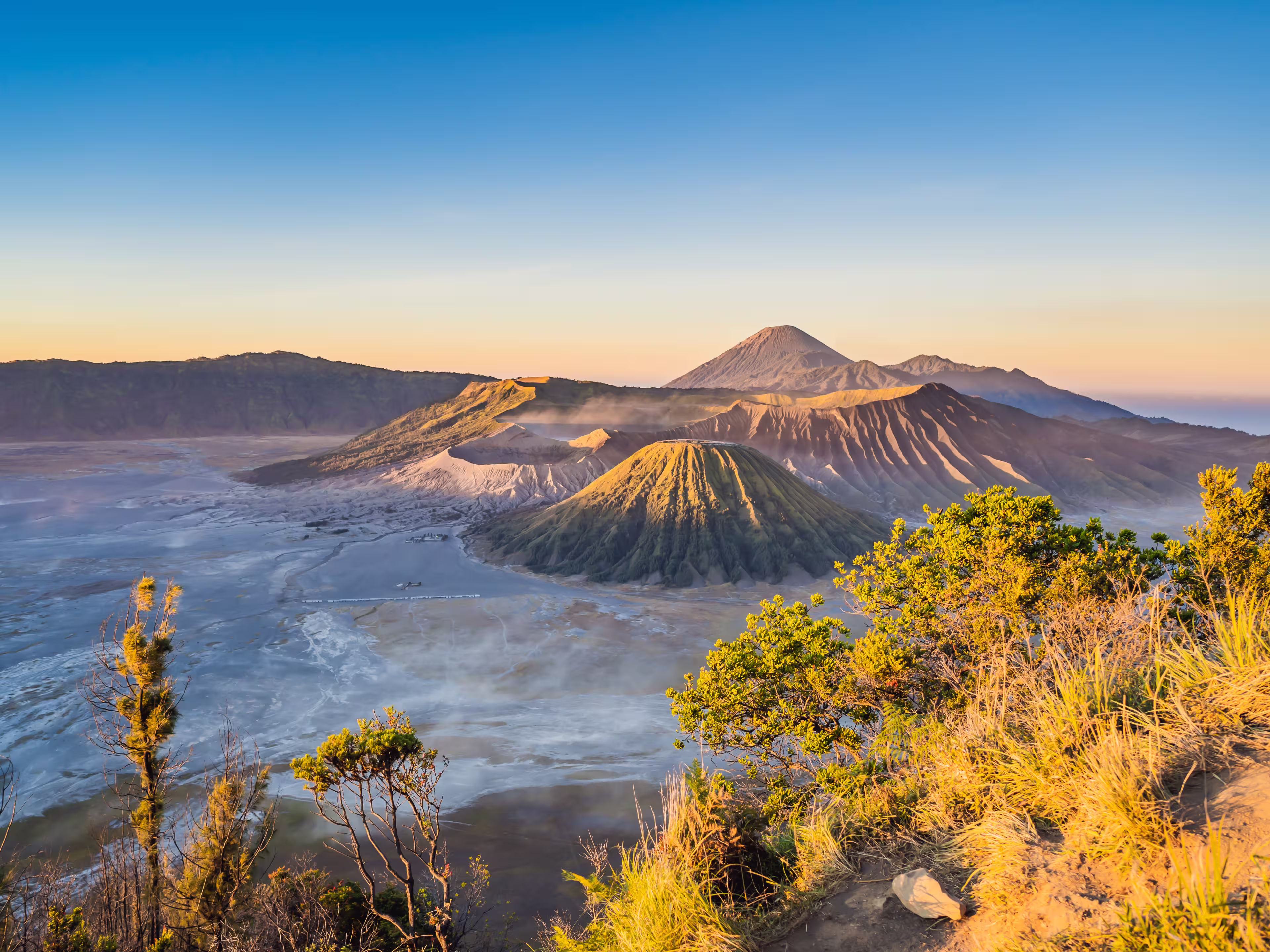 Sunrise at the Bromo Tengger Semeru National Park on the Java Island, Indonesia. View on the Bromo or Gunung Bromo on Indonesian, Semeru and other volcanoes located inside of the Sea of Sand within