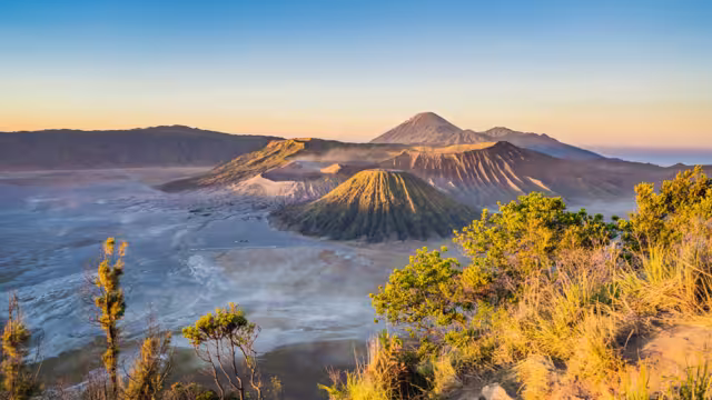 Sunrise at the Bromo Tengger Semeru National Park on the Java Island, Indonesia. View on the Bromo or Gunung Bromo on Indonesian, Semeru and other volcanoes located inside of the Sea of Sand within