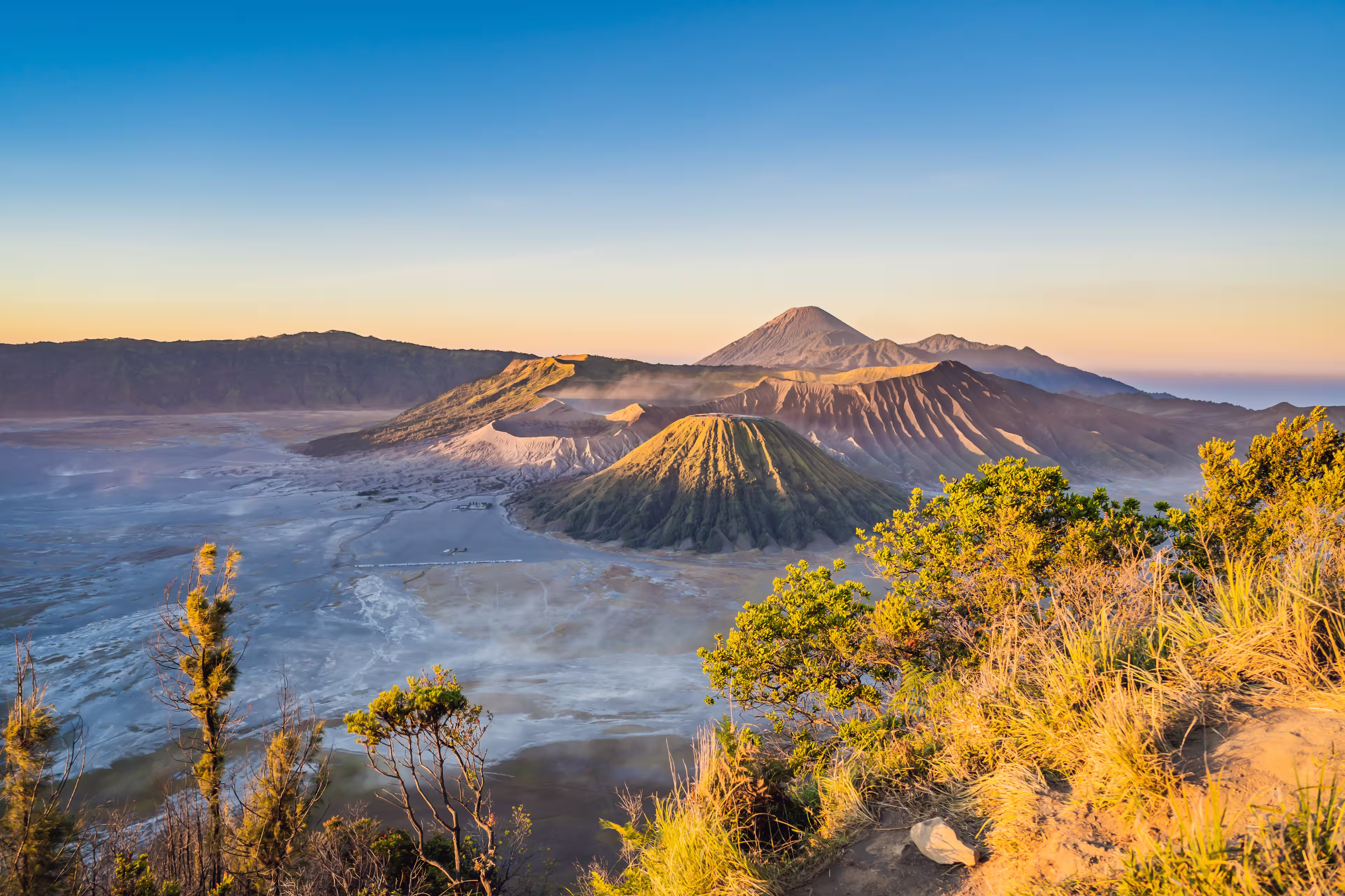 Sunrise at the Bromo Tengger Semeru National Park on the Java Island, Indonesia. View on the Bromo or Gunung Bromo on Indonesian, Semeru and other volcanoes located inside of the Sea of Sand within