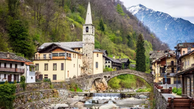 Fontainemore alpine village on the Lys river in a forest in the valley of Gressoney near Monte Rosa during spring. Aosta Valley, Aosta, Italy.