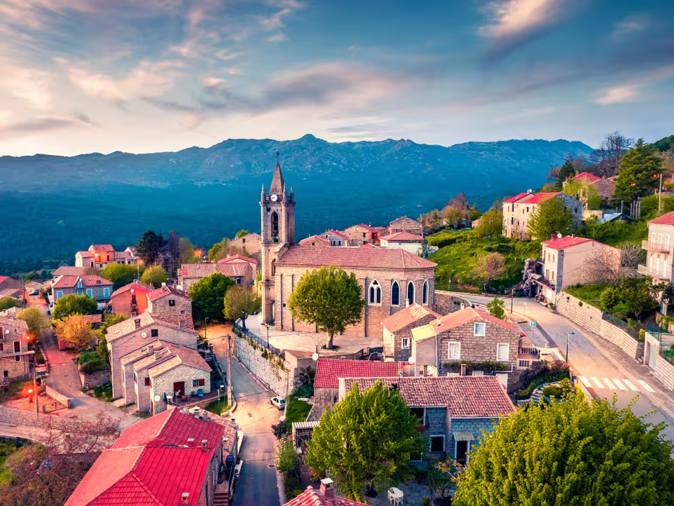 View from flying drone. Astonishing evening cityscape of Zonza town, commune in the Corse-du-Sud department of France. Fantastic sunset on Corsica island, France, Europe.