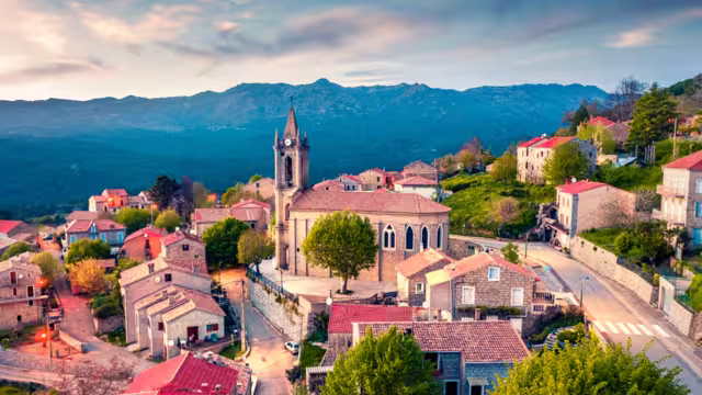 View from flying drone. Astonishing evening cityscape of Zonza town, commune in the Corse-du-Sud department of France. Fantastic sunset on Corsica island, France, Europe.