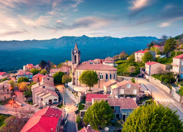 View from flying drone. Astonishing evening cityscape of Zonza town, commune in the Corse-du-Sud department of France. Fantastic sunset on Corsica island, France, Europe.