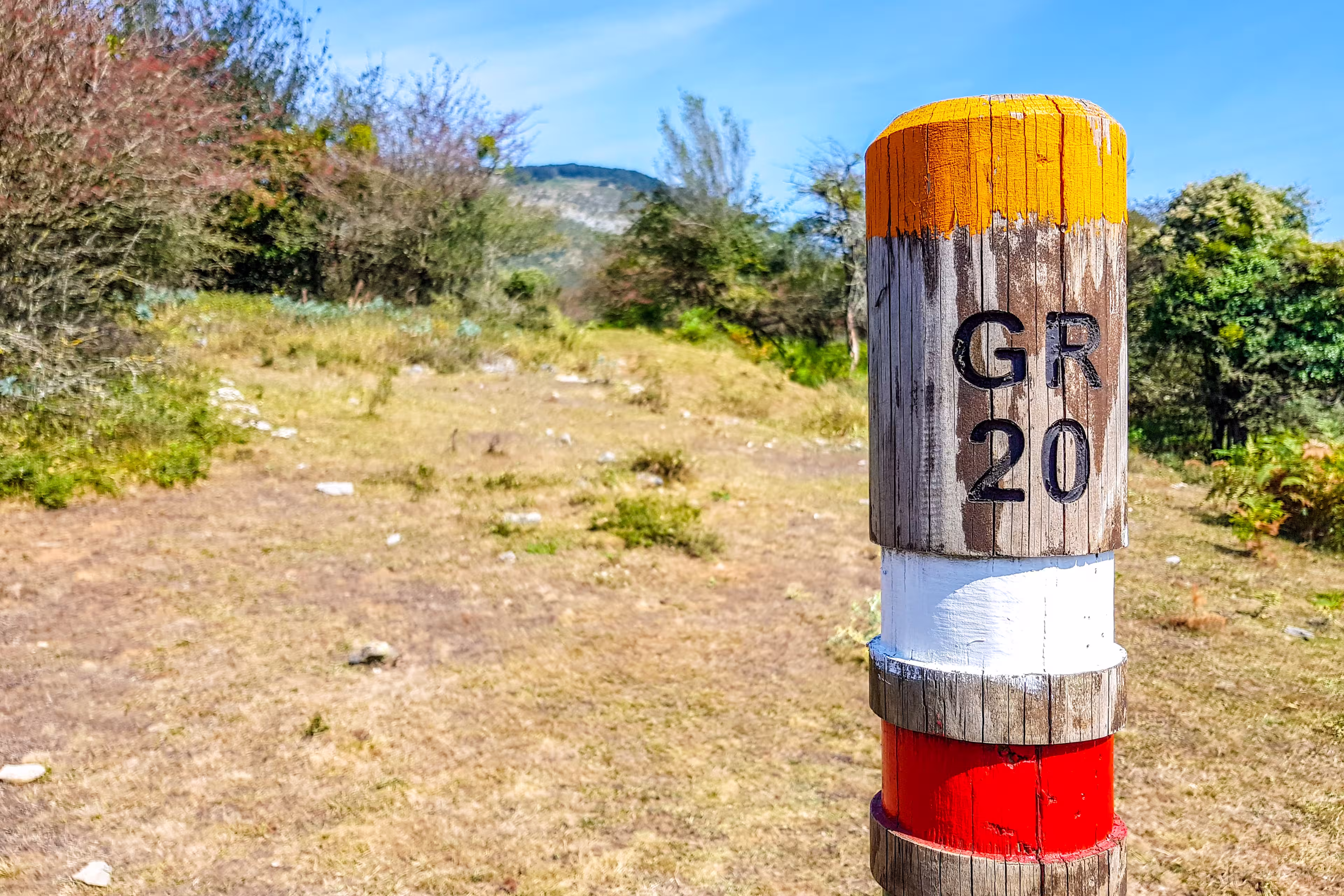 GR20 trail sign in the Araiz valley with the Aralar mountains from the Betelu area, Navarre. Spain