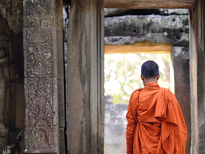 cambodia angkor temple monk walking doorway