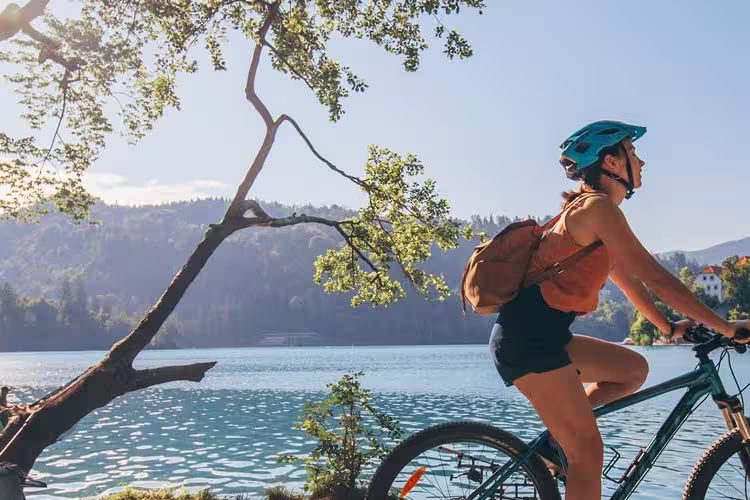 Traveller rides bike around Lake Bled
