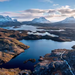Scottish Mountains in the snow along the Cul Mor ridge by drone