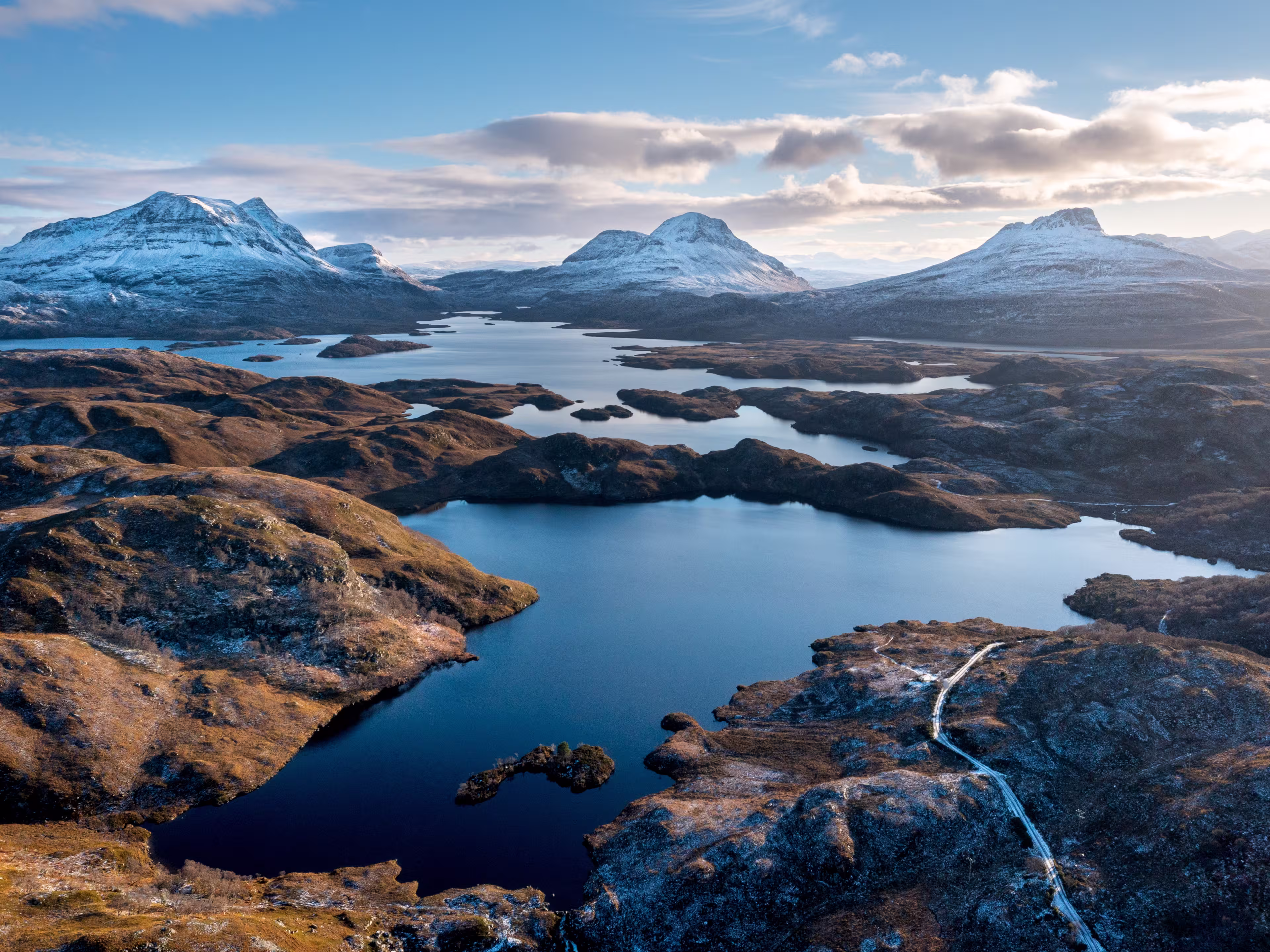 Scottish Mountains in the snow along the Cul Mor ridge by drone